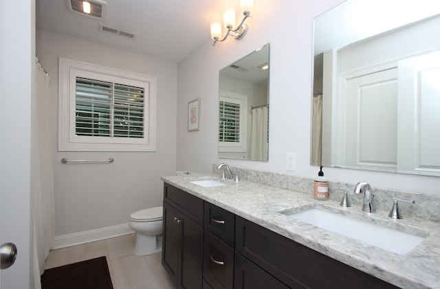 229 Long Hill Cross Rd, Shelton, CT 06484 - full bathroom featuring double vanity, toilet, and baseboards
