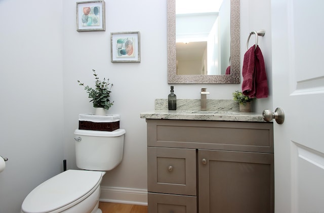 229 Long Hill Cross Rd, Shelton, CT 06484 - bathroom with toilet, vanity, baseboards, and wood finished floors
