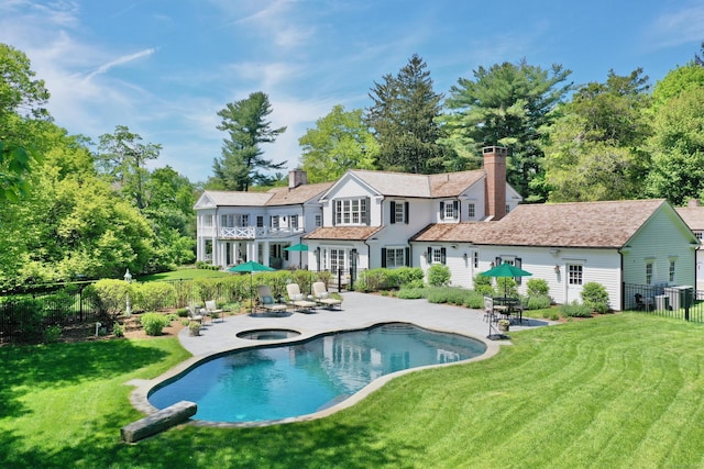 1191 Oenoke Rdg, New Canaan, CT 06840 - rear view of property with a patio, a chimney, and an in-ground hot tub