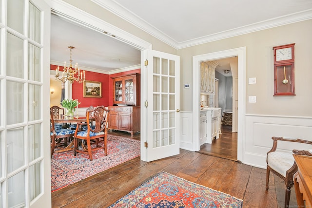 1191 Oenoke Rdg, New Canaan, CT 06840 - interior space featuring dark wood-style flooring, ornamental molding, wainscoting, a chandelier, and french doors