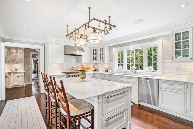 1191 Oenoke Rdg, New Canaan, CT 06840 - kitchen with dishwasher, wall chimney exhaust hood, tasteful backsplash, ornamental molding, and a breakfast bar