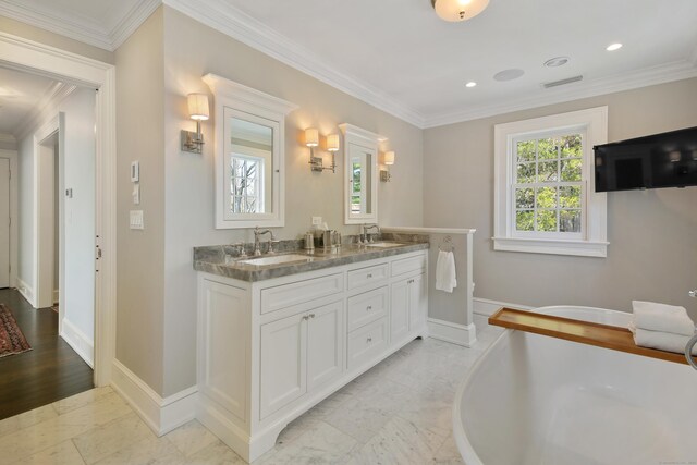 1191 Oenoke Rdg, New Canaan, CT 06840 - bathroom featuring double vanity, baseboards, ornamental molding, a freestanding bath, and recessed lighting