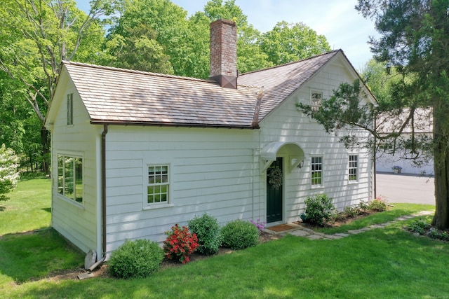 1191 Oenoke Rdg, New Canaan, CT 06840 - view of front of home with a chimney and a front lawn