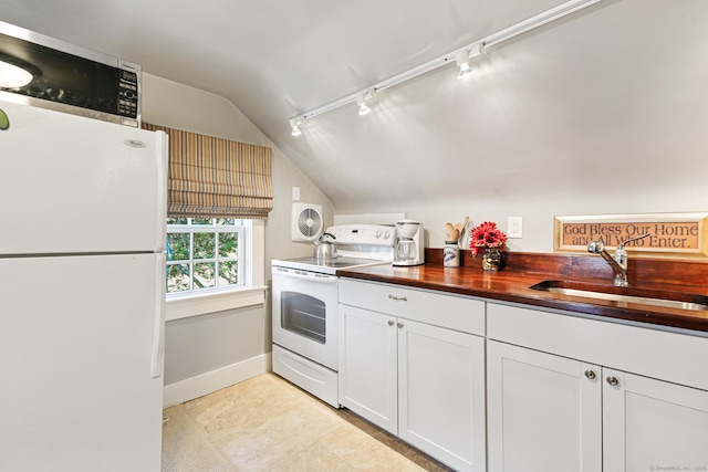 1191 Oenoke Rdg, New Canaan, CT 06840 - kitchen with white appliances, rail lighting, lofted ceiling, a sink, and butcher block countertops