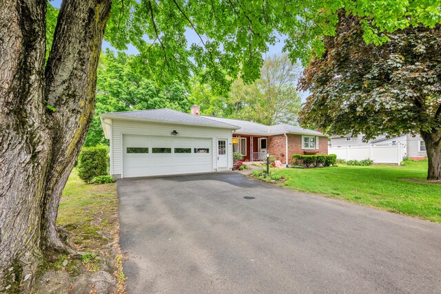 single story home with a chimney and driveway