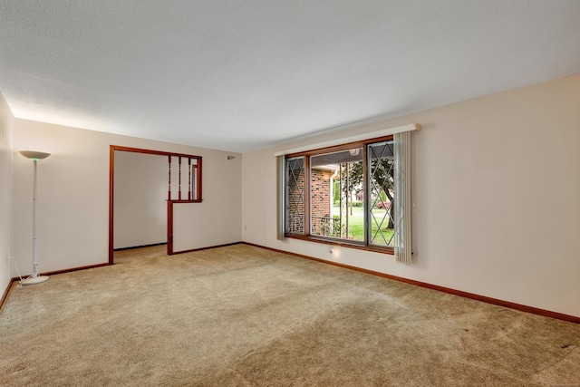 unfurnished room with carpet and baseboards