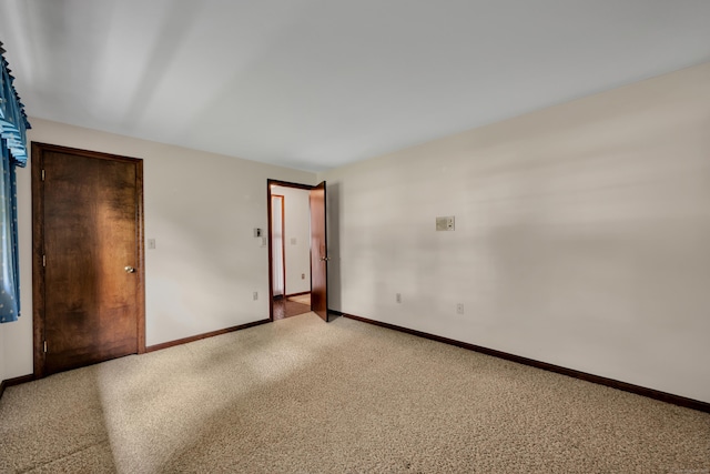 unfurnished bedroom with light colored carpet and baseboards