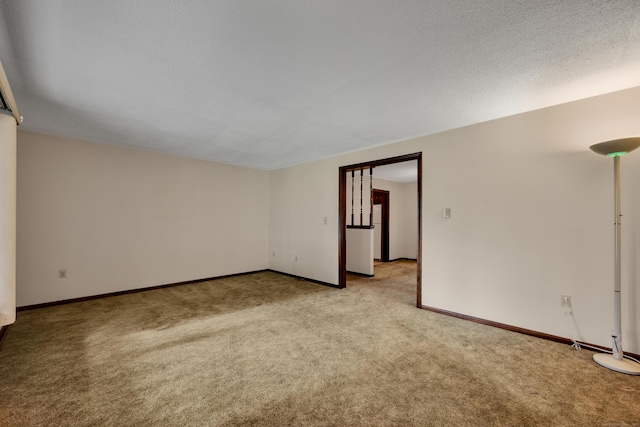 spare room with light colored carpet and baseboards