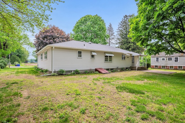 back of house with a yard