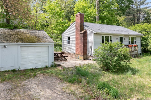 2517 Main St, Coventry, CT 06238 - view of side of home with a chimney, an outbuilding, driveway, a garage, and a wooden deck
