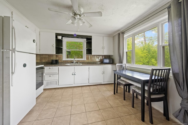 2517 Main St, Coventry, CT 06238 - kitchen featuring freestanding refrigerator, open shelves, a sink, decorative backsplash, and white cabinets