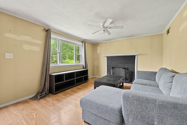 2517 Main St, Coventry, CT 06238 - living area featuring wood finished floors, a textured ceiling, a ceiling fan, crown molding, and a fireplace
