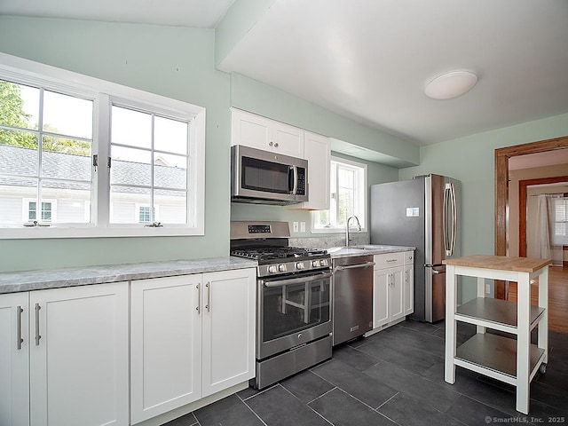 283 Quinnipiac Ave, North Haven, CT 06473 - kitchen featuring appliances with stainless steel finishes, a sink, white cabinets, and light countertops