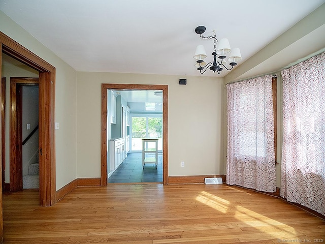283 Quinnipiac Ave, North Haven, CT 06473 - spare room with light wood-type flooring, a chandelier, and baseboards