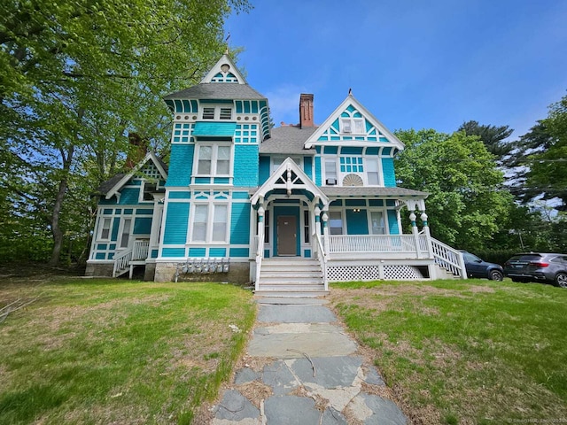 36 Bellevue Ave, Bristol, CT 06010 - victorian house featuring a porch, a front lawn, roof with shingles, and a chimney
