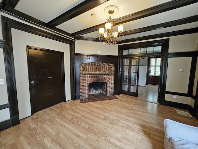 36 Bellevue Ave, Bristol, CT 06010 - unfurnished living room featuring wood finished floors, french doors, beam ceiling, a tile fireplace, and a chandelier