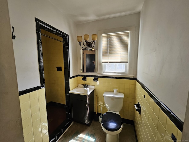 36 Bellevue Ave, Bristol, CT 06010 - full bathroom featuring tile walls, toilet, a stall shower, wainscoting, and vanity