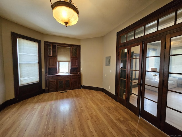 36 Bellevue Ave, Bristol, CT 06010 - empty room with french doors, light wood-style floors, and baseboards