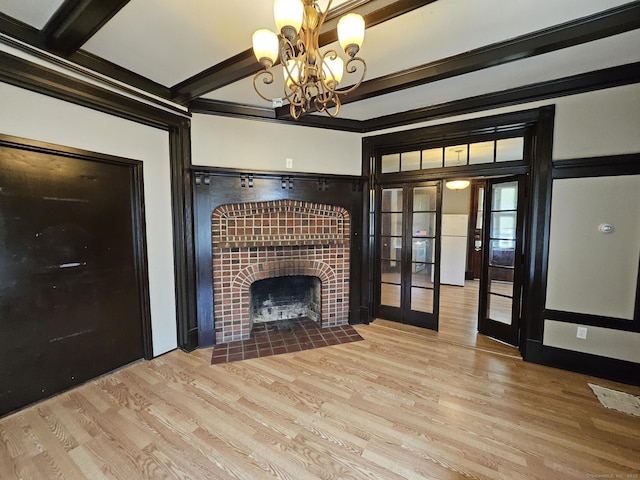 36 Bellevue Ave, Bristol, CT 06010 - unfurnished living room featuring french doors, wood finished floors, a chandelier, a tiled fireplace, and beamed ceiling