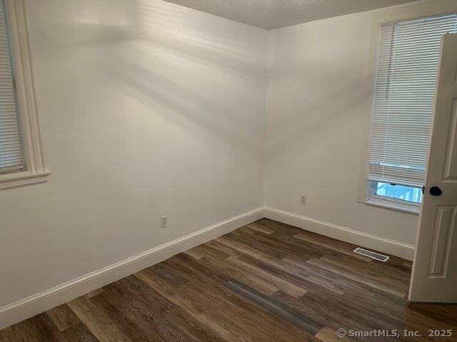 36 Bellevue Ave, Bristol, CT 06010 - empty room with dark wood-style flooring and baseboards