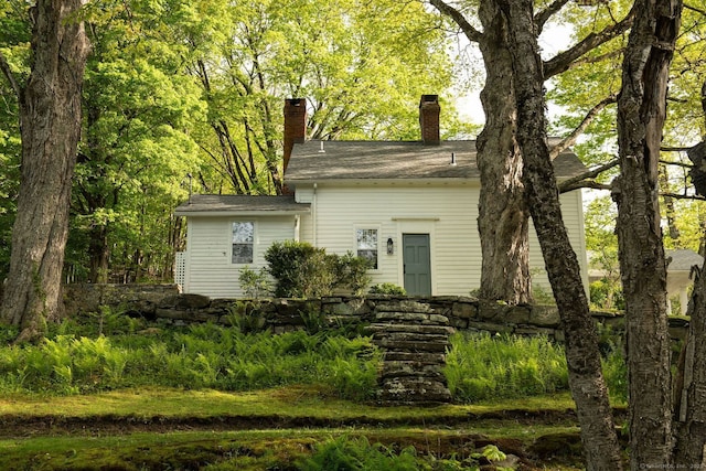 view of front of home featuring a chimney