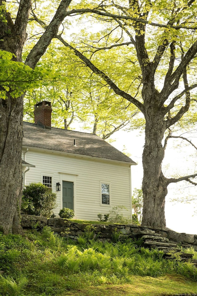 view of property exterior featuring a chimney