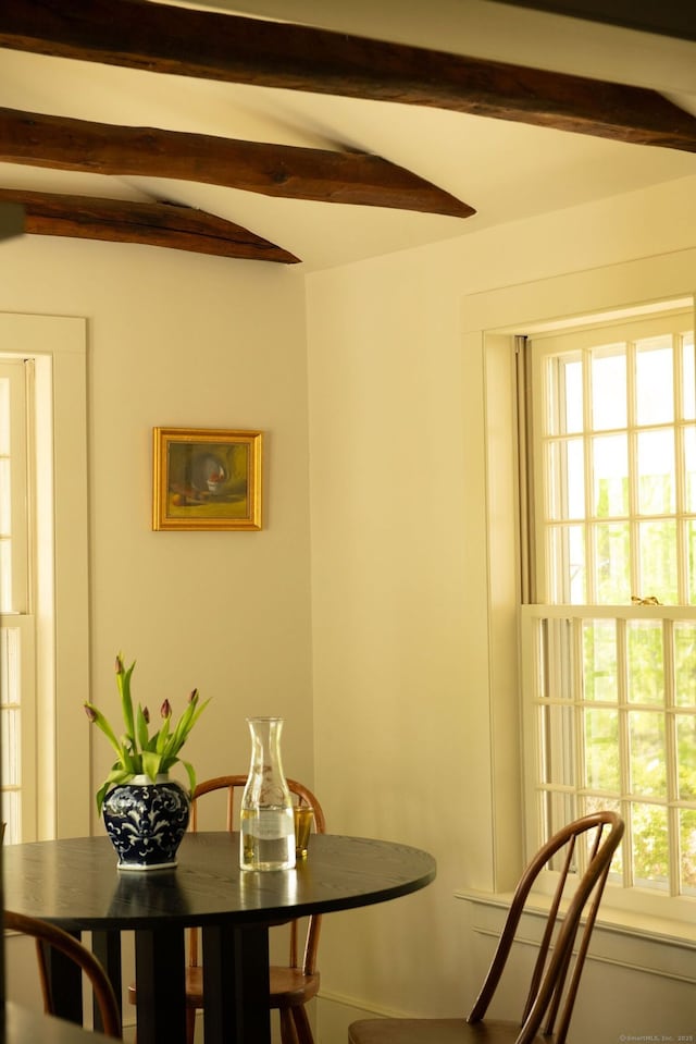 dining room with beam ceiling
