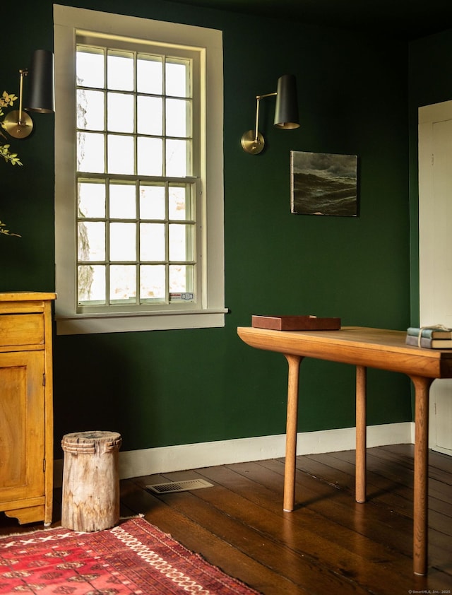 dining space with dark wood-style floors and baseboards