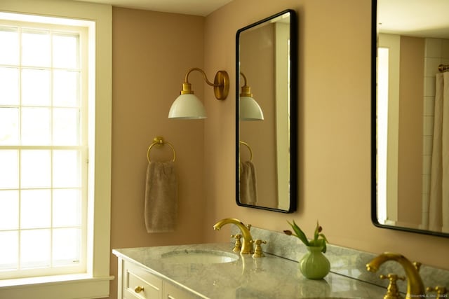 bathroom with healthy amount of natural light and vanity