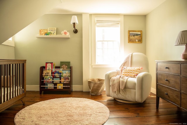 living area featuring hardwood / wood-style flooring and baseboards