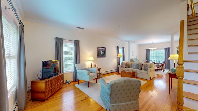 94 E Ridge Rd, Middletown, CT 06457 - living area with stairs, a baseboard radiator, light wood-style flooring, a chandelier, and ornamental molding