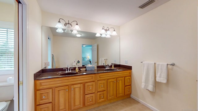 94 E Ridge Rd, Middletown, CT 06457 - bathroom with double vanity, tile patterned floors, toilet, and baseboards