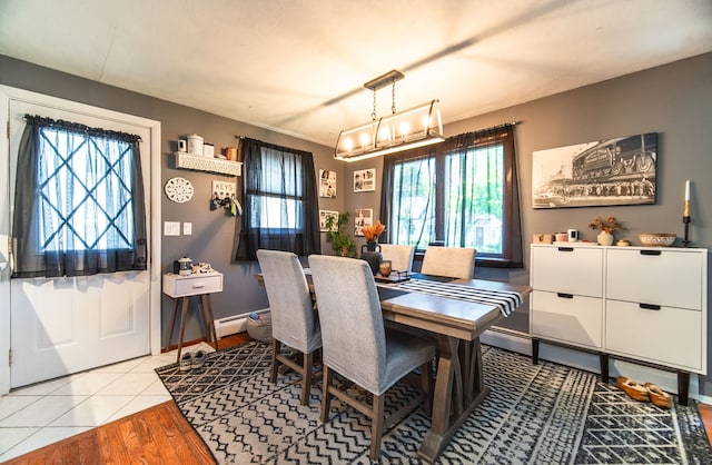 51 Palmetto Trl, East Haven, CT 06512 - dining space featuring healthy amount of natural light, a baseboard heating unit, a chandelier, and wood finished floors