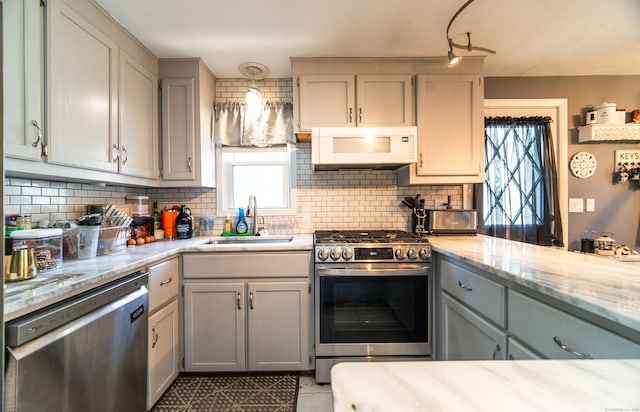 51 Palmetto Trl, East Haven, CT 06512 - kitchen with stainless steel appliances, a sink, decorative backsplash, and gray cabinetry