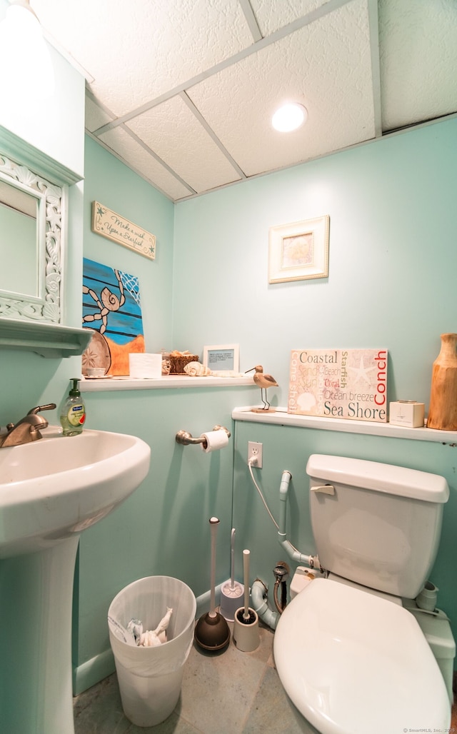 51 Palmetto Trl, East Haven, CT 06512 - half bathroom with a paneled ceiling, toilet, and a sink