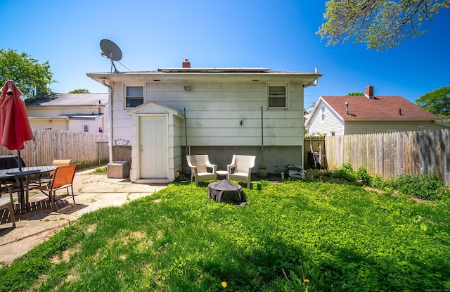 51 Palmetto Trl, East Haven, CT 06512 - back of property featuring a patio area and a chimney