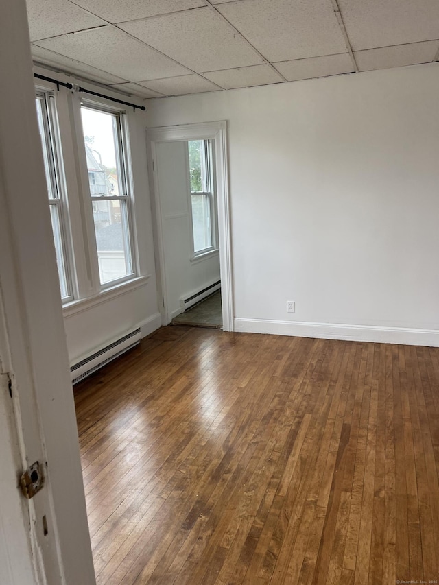51 Griswold St, Meriden, CT 06450 - spare room with a baseboard radiator, a drop ceiling, a baseboard heating unit, wood-type flooring, and baseboards