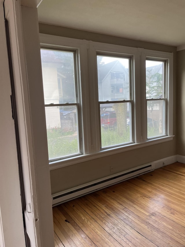 51 Griswold St, Meriden, CT 06450 - unfurnished room with a baseboard radiator, healthy amount of natural light, and light wood-type flooring
