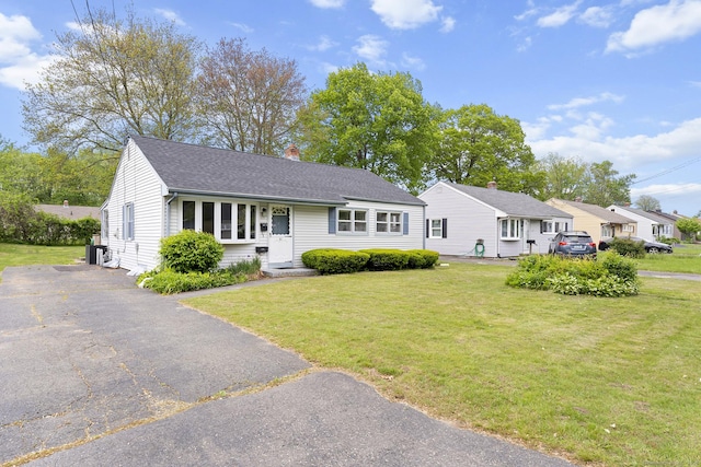 81 Montague Cir E, Hartford, CT 06118 - view of front facade with a chimney, a front lawn, and roof with shingles