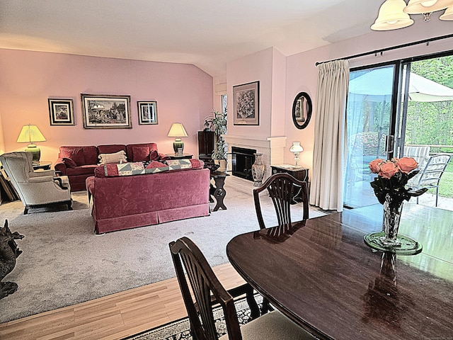 470 Heritage Vlg Unit A, Southbury, CT 06488 - dining space featuring wood finished floors, a fireplace, and vaulted ceiling