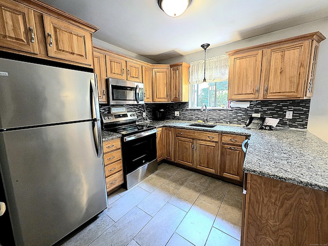 470 Heritage Vlg Unit A, Southbury, CT 06488 - kitchen featuring stainless steel appliances, a sink, backsplash, hanging light fixtures, and brown cabinetry
