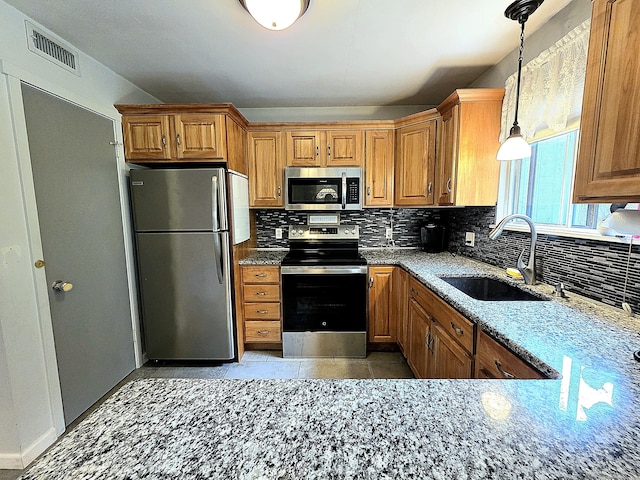 470 Heritage Vlg Unit A, Southbury, CT 06488 - kitchen featuring appliances with stainless steel finishes, a sink, and brown cabinets