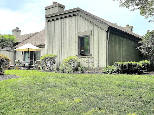 470 Heritage Vlg Unit A, Southbury, CT 06488 - view of property exterior with a chimney and a lawn
