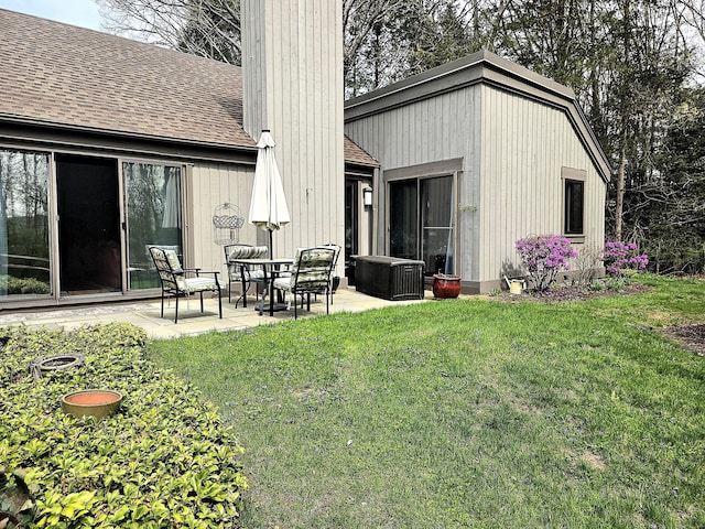 470 Heritage Vlg Unit A, Southbury, CT 06488 - back of house with a shingled roof, a patio area, a chimney, and a lawn