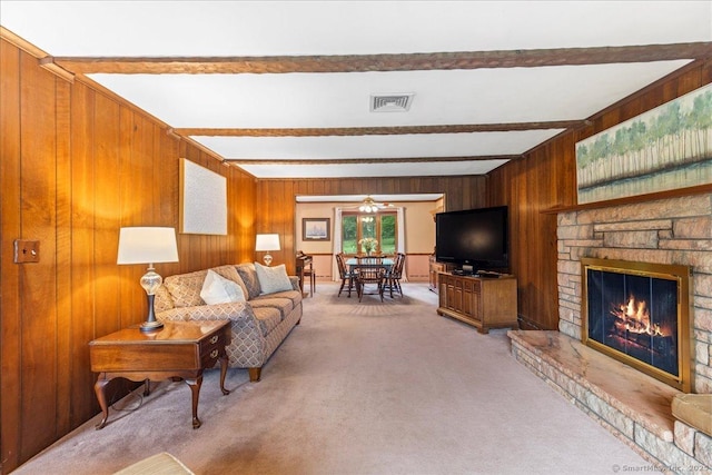 120 Peters Ln, Stratford, CT 06614 - living room with beamed ceiling, light carpet, wooden walls, a stone fireplace, and a ceiling fan