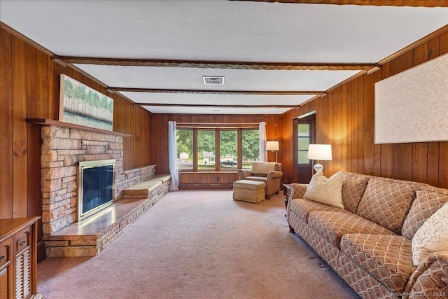120 Peters Ln, Stratford, CT 06614 - carpeted living area featuring beam ceiling, wood walls, and a fireplace