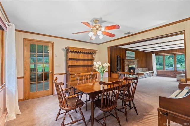 120 Peters Ln, Stratford, CT 06614 - carpeted dining room with a fireplace, ceiling fan, and crown molding