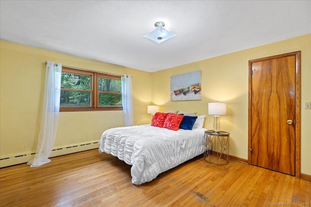 120 Peters Ln, Stratford, CT 06614 - bedroom with hardwood / wood-style flooring, baseboards, and a baseboard radiator