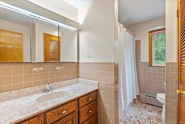120 Peters Ln, Stratford, CT 06614 - bathroom featuring tile walls, a baseboard heating unit, toilet, vanity, and wainscoting