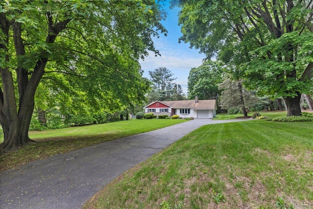 120 Peters Ln, Stratford, CT 06614 - single story home featuring asphalt driveway, an attached garage, a front lawn, and a chimney